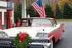 Classic 50's car with a Christmas wreath on the front grille