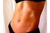 Cette femme's belly is flat becaue of very low body fat, not tummy crunches.